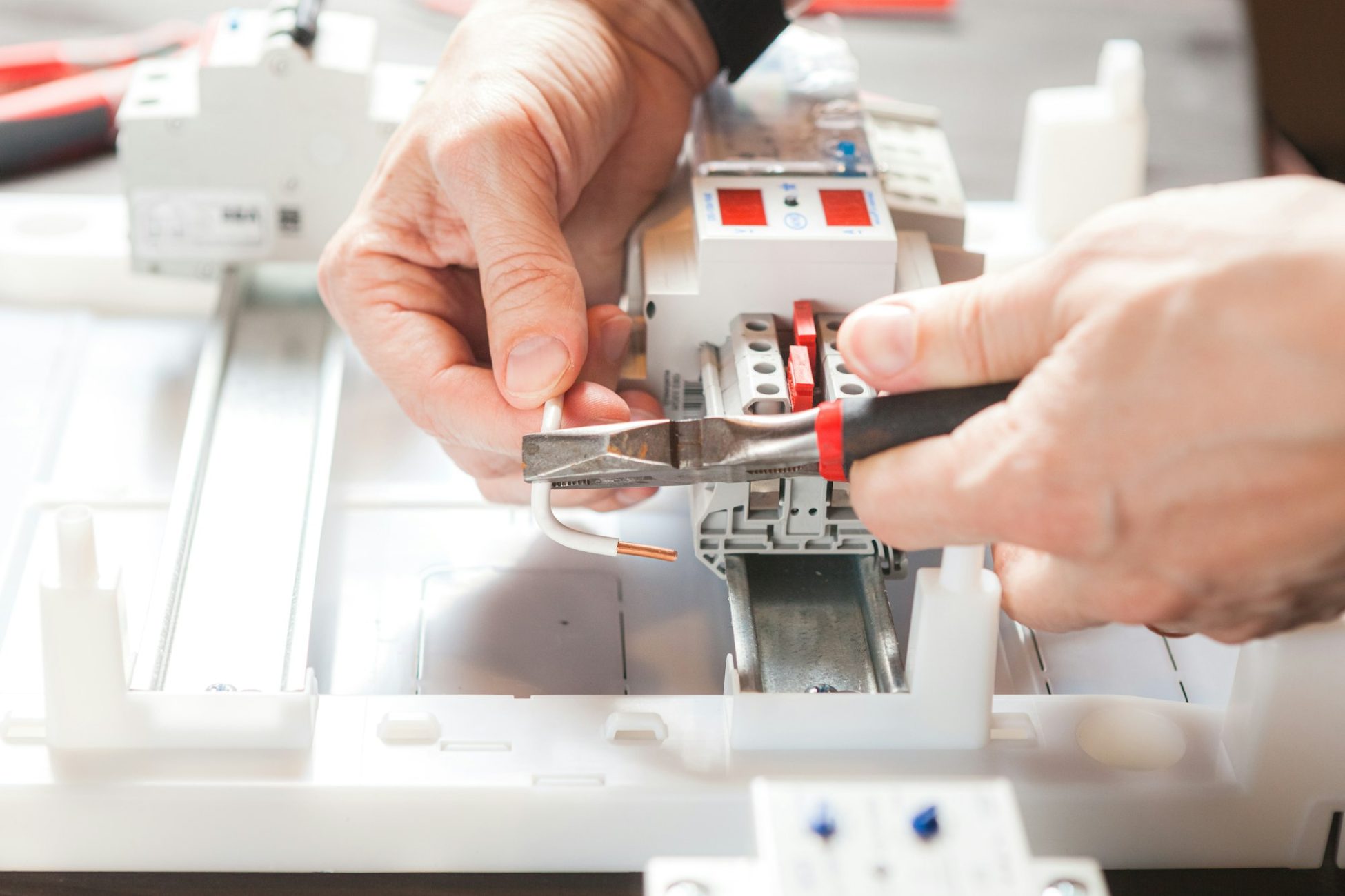 Men's hands close-up. Installation of an electric meter.